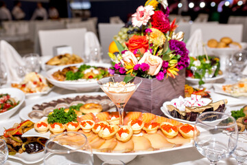 Seafood appetizers. Sandwiches with a game, a tartlet appetizer with sauce and red caviar, sliced red salmon fish and cream sauce with scrambled eggs.