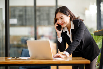 Fototapeta premium Portrait of Young Asian woman hand freelancer is working her job on computer tablet in modern office. Doing accounting analysis report real estate investment data, Financial and tax systems concept.
