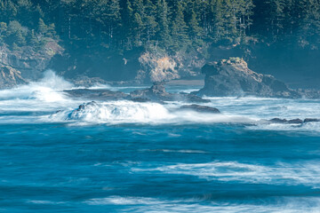 Waves crashing over rock formation