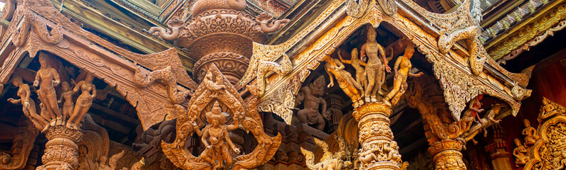 Wooden Temple in Pattaya. Traveling in Thailand. Wooden sculptures of beautiful carved patterns on the roof.