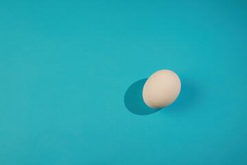 White egg and yolk. Raw eggs on pastel blue background. Concept happy easter. Design, Fine Art, Minimalism