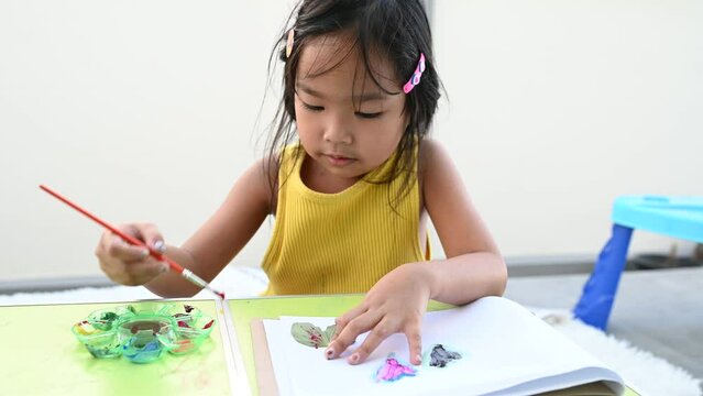 Asian girls having fun painting and painting at home.