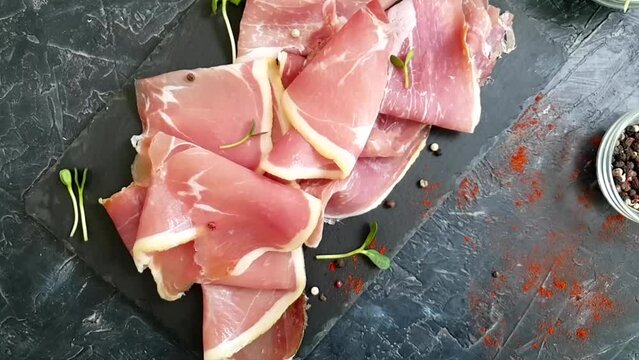 Jamon slice on old dark concrete background