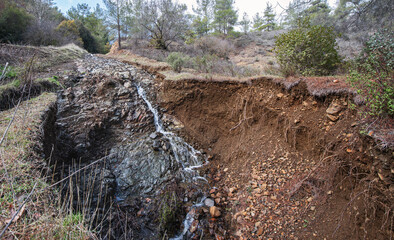 Landslide on a forest road, ground washed out by heavy rainfall