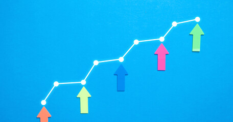 Fototapeta na wymiar Colorful arrows and growth graph on the blue background.
