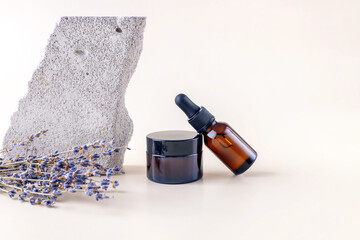 containers for cosmetics, lavender branches and a stone on a beige background. mockup of cosmetics...
