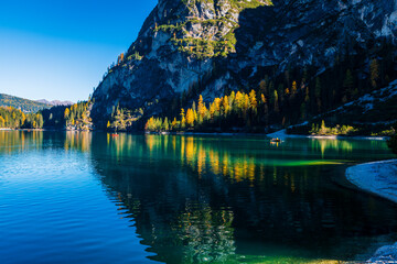Fototapeta premium Autumn and golden reflections on Lake Braies. Park of the Dolomites.