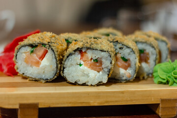 Hot fried Sushi Roll with shrimp, cucumber and cheese philadelphia. Sushi menu. Japanese food. Futomaki