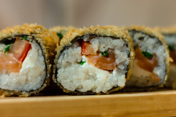 Hot fried Sushi Roll with shrimp, cucumber and cheese philadelphia. Sushi menu. Japanese food. Futomaki