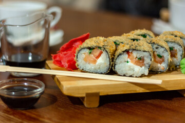 Hot fried Sushi Roll with shrimp, cucumber and cheese philadelphia. Sushi menu. Japanese food. Futomaki