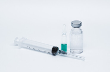 Medicinal or cosmetic ampoules jars of vaccines isolated on white background as a concept of cosmetology medicine and treatment with syringes injections.