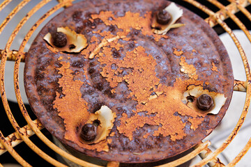 Rusty grunge texture metal HVAC air conditioner grill. AC unit fan in need of repair.