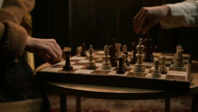 guy with a girl play chess with cinematic light on the background of the classics