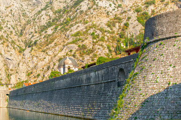Detail of the ancient stone wall of the Gurdic Gate near the pond water in the old town of Kotor, Montenegro - 487396157