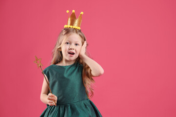 Cute girl in fairy dress with golden crown and magic wand on pink background, space for text....