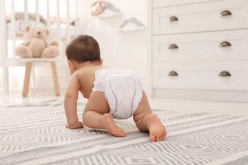 Cute baby crawling on floor at home, back view - obrazy, fototapety, plakaty
