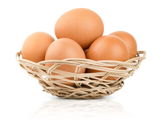 wicker plate with eggs on an isolated white background