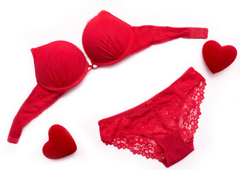 Panties and bra under the lace of red color set of female lower intimate romantic underwear on a white background