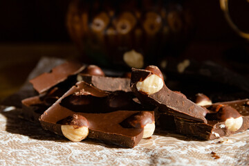 Black, bitter chocolate with pine nuts with coffee