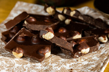 Black, bitter chocolate with pine nuts with coffee