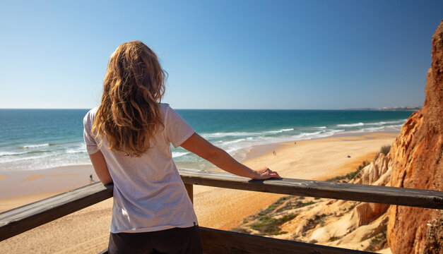 woman looking at beautiful sea and cliff view- Algarve