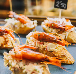 Different assorted canapes of bread with crab, ham and vegetables