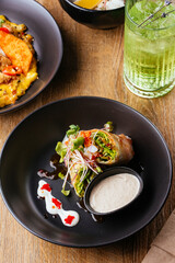 asian spring rolls with vegetables on a wooden background. resta