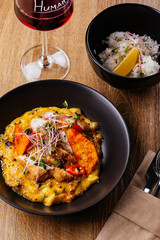chicken curry with a black plate on a wooden background. restaur