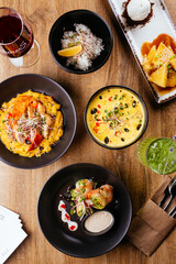 chicken curry with a black plate on a wooden background. restaur