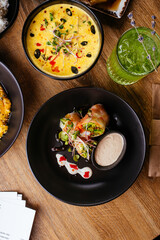asian spring rolls with vegetables on a wooden background. resta