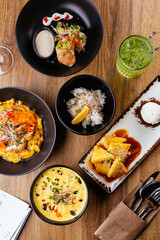 chicken curry with a black plate on a wooden background. restaur