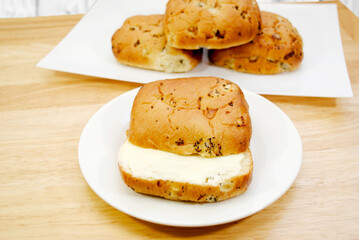 A Buttered Onion Roll Served on a White Plate