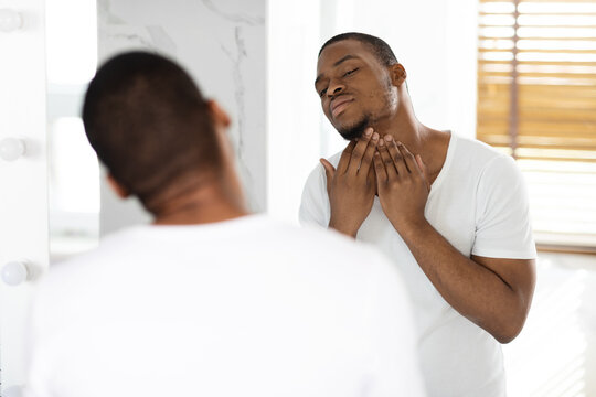 Ingrown Hair Problem. Portrait Of Unshaved Black Guy Touching Neck With Bristle