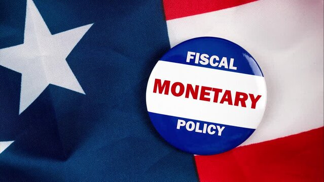 fiscal monetary policy text quote on election button laying on the star spangled banner. united states of america concept.