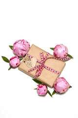 gift box, pink peonies, wooden heart on a white background