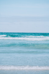 Pristine shoreline and blue skies at Garrapatero Beach in Galapagos, Ecuador.