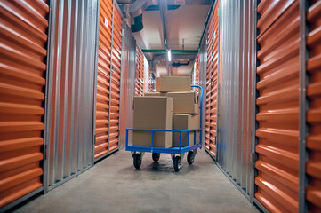 Boxed goods placed on the platform trolley in the storage room