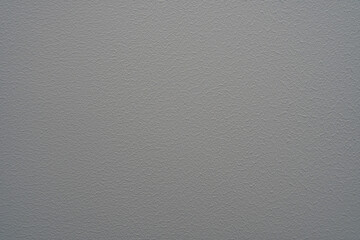 Gray wall painted with interior paint, textured background.