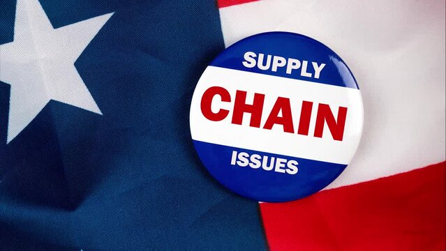 Supply Chain Issues Text Quote On Election Button Laying On The Star Spangled Banner. United States Of America Concept.