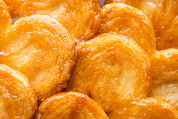 Puff pastry palms with honey. pastries. Detail of the puff pastry dough. Dessert with flour, sugar, honey and egg.