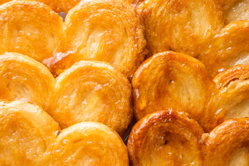 Puff pastry palms with honey. pastries. Detail of the puff pastry dough. Dessert with flour, sugar, honey and egg.