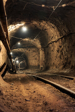 Narrow gauge railroad in the underground mine horizon. Technologies of mining of minerals by the underground method. Underground mine for mining ore