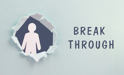 The words break through are standing on a blue colored background, hole torn paper with silhouette of man, planning goals and possibilities, freedom concept