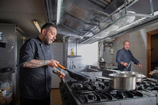 Chef making flambe in frying pan