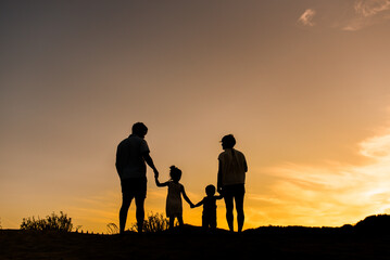 Anonymous family with kids walking on nature