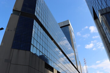 Fototapeta na wymiar Genova, Italy - January 29, 2022: Beautiful modern high-rise buildings against the sky. 3d illustration on the theme of business success and technology. clouds reflection on the mirror.