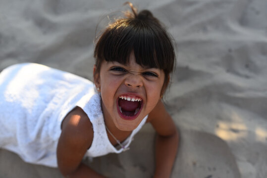 Excited Girl With Mouth Opened On Sand