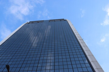 Genova, Italy - January 29, 2022: Beautiful modern high-rise buildings against the sky. 3d illustration on the theme of business success and technology. clouds reflection on the mirror.