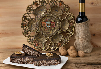 Matzo chocolate cake over blurred Passover plate for Jewish Pesach holidays. Selective focus....