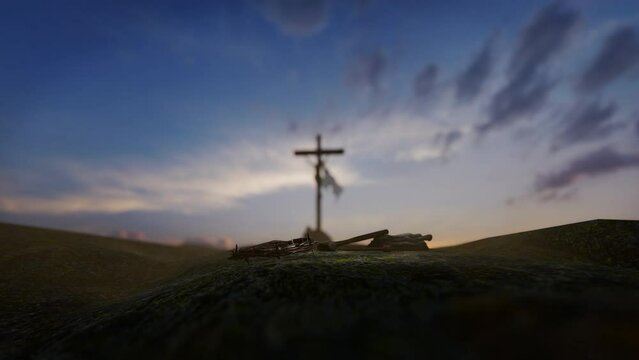 Crucifixion of Jesus Christ with thorn crown, nails, hammer and a rope against beautiful sunrise, tilt 4K